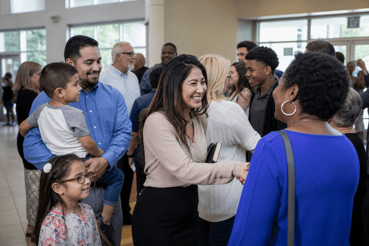 Multicultural American church community greeting one another after worship